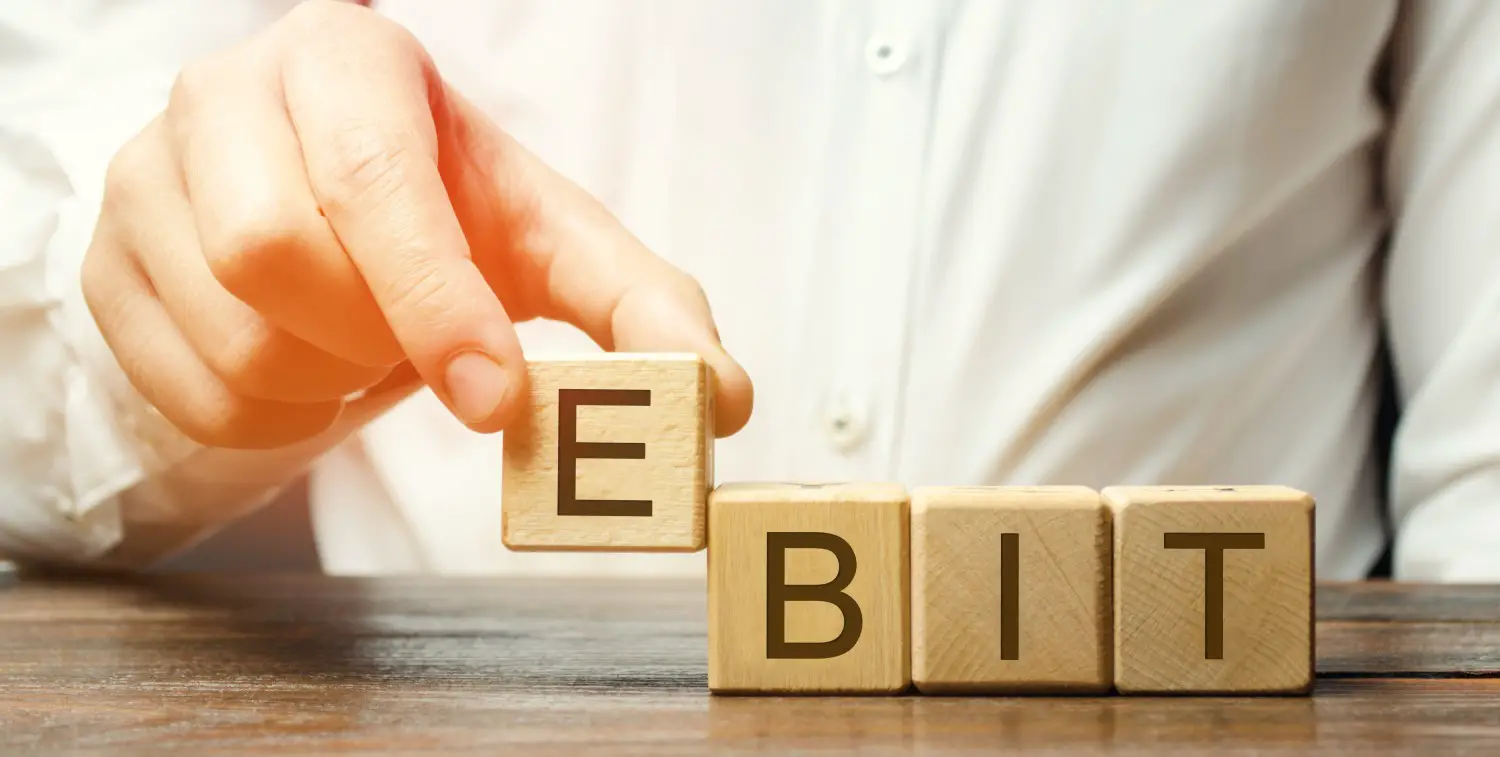 Businessman puts wooden blocks with word EBIT